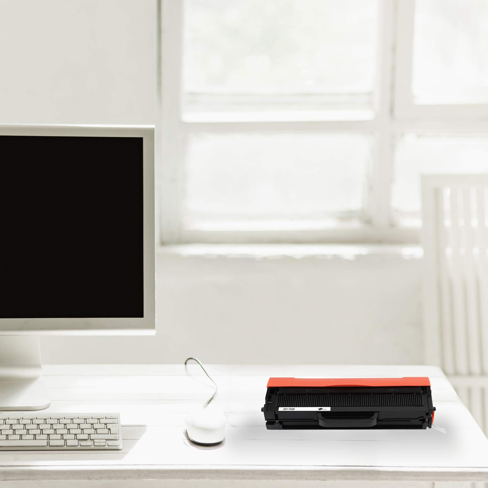 Black toner cartridge with orange top on an office desk