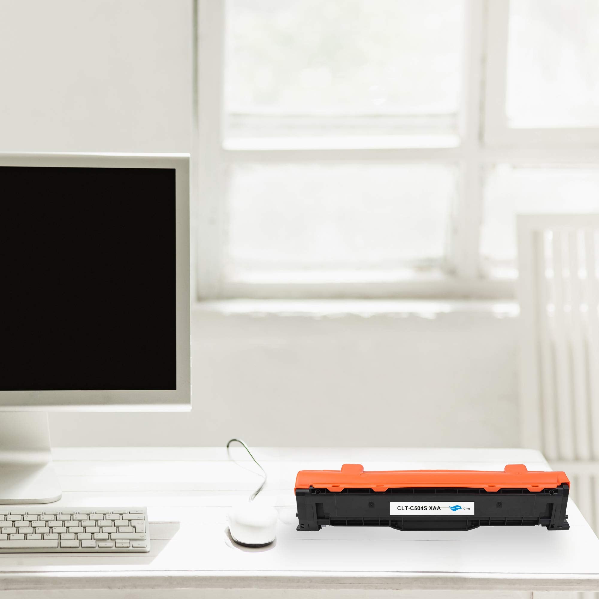 Cyan toner cartridge resting on desk